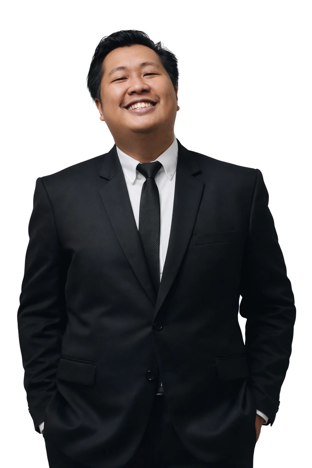 Ilham Saputra smiling, in a black suit and tie.
